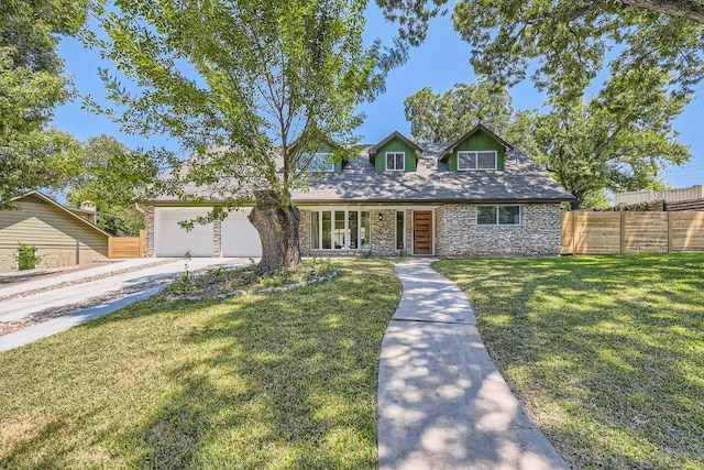 cape cod home featuring a garage and a front yard