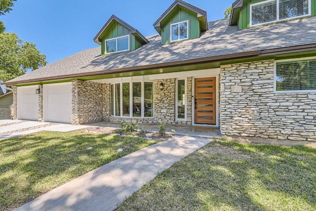 cape cod home with a garage and a front yard