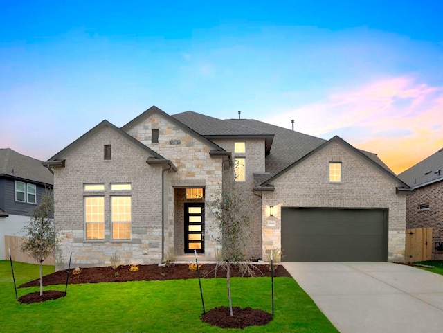 view of front of property with a lawn and a garage