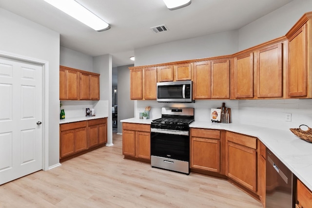 kitchen with light wood-type flooring and stainless steel appliances