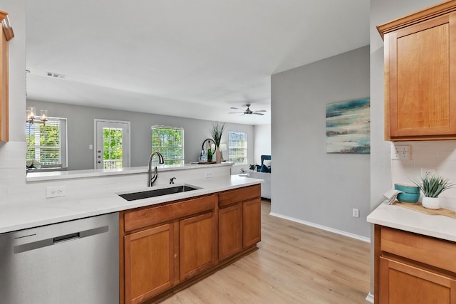 kitchen featuring dishwasher, ceiling fan with notable chandelier, a healthy amount of sunlight, and light hardwood / wood-style flooring