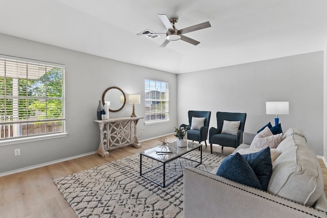 living room featuring ceiling fan and light hardwood / wood-style floors