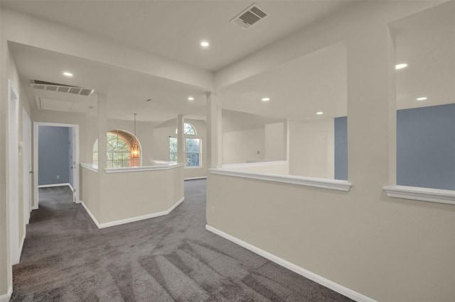 interior space featuring recessed lighting, visible vents, dark carpet, and baseboards