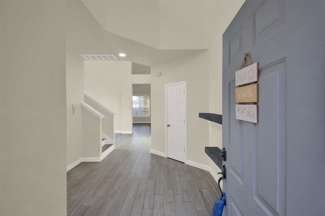 entryway with lofted ceiling and hardwood / wood-style floors