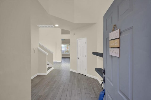 interior space with visible vents, baseboards, and wood finished floors