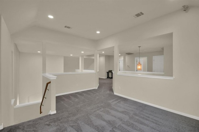 spare room with recessed lighting, dark carpet, visible vents, and baseboards