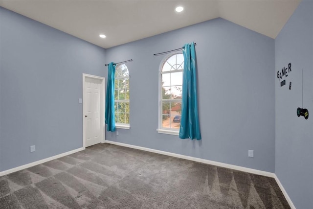 empty room featuring vaulted ceiling, carpet floors, recessed lighting, and baseboards