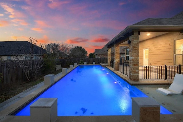 view of swimming pool featuring a fenced in pool, a fenced backyard, and a patio