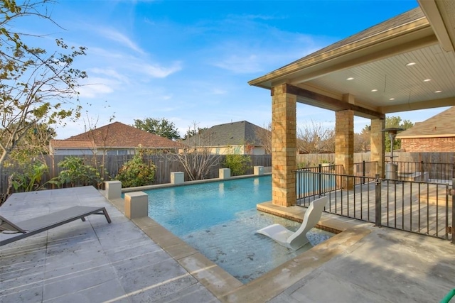 view of swimming pool with a fenced backyard, a fenced in pool, and a patio