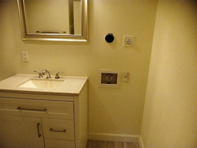 bathroom with baseboards and vanity