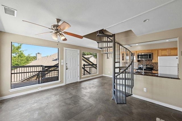 interior space featuring ceiling fan and a healthy amount of sunlight