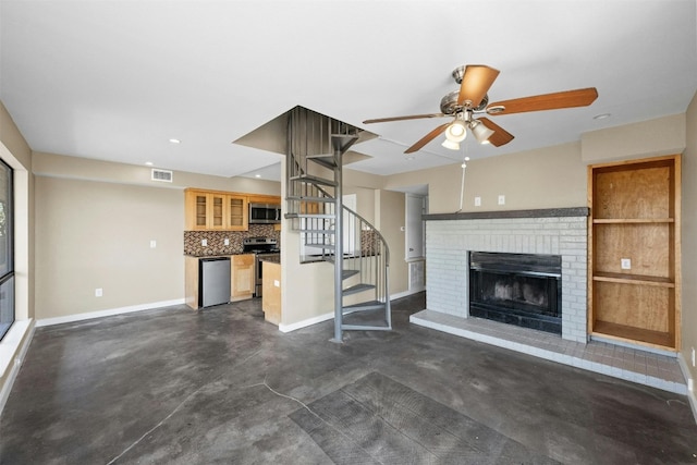 unfurnished living room featuring a fireplace and ceiling fan