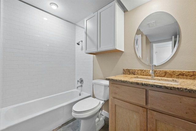 full bathroom with toilet, tiled shower / bath, and vanity