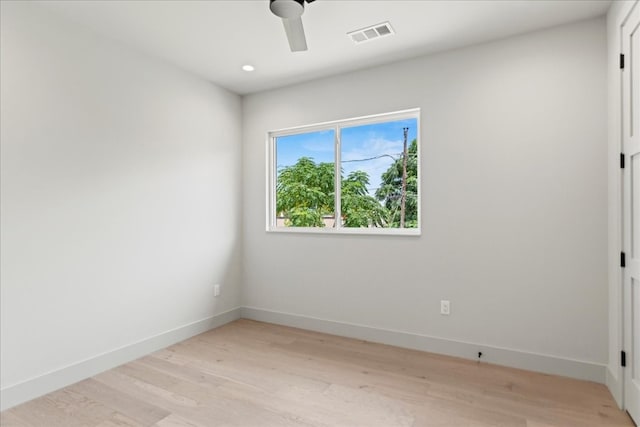 empty room featuring light wood-type flooring and ceiling fan