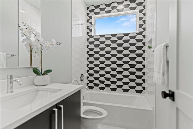 full bathroom featuring toilet, tiled shower / bath, and vanity