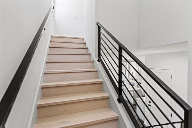 stairs featuring hardwood / wood-style flooring