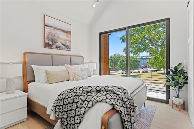 bedroom with light wood-type flooring, high vaulted ceiling, and access to exterior