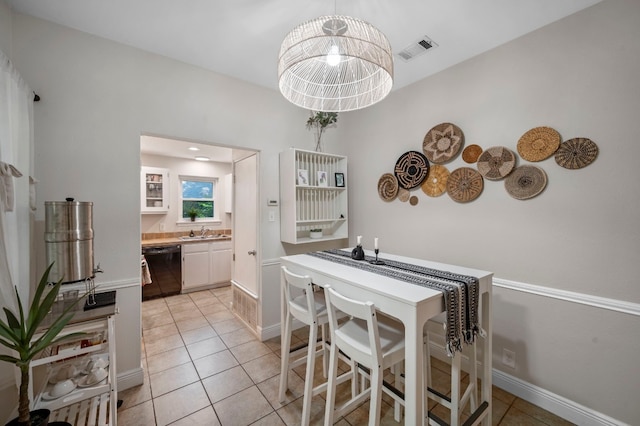 tiled dining space featuring sink