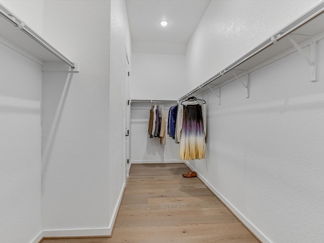 spacious closet with light hardwood / wood-style floors