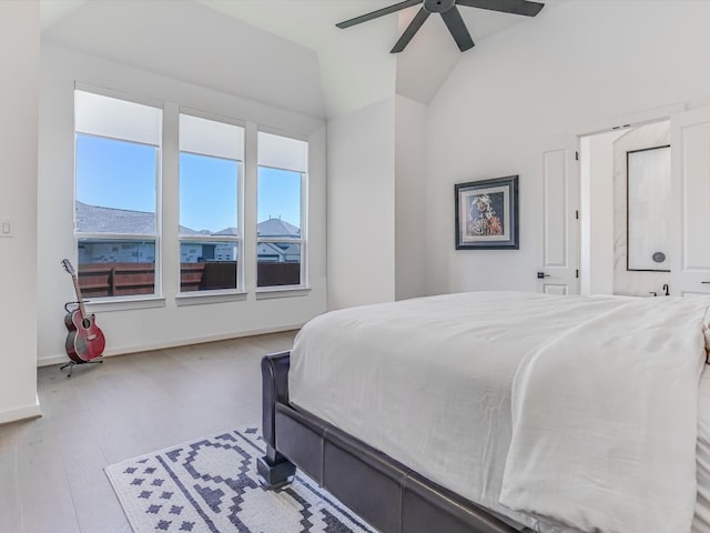 bedroom featuring light wood-type flooring, ceiling fan, and lofted ceiling