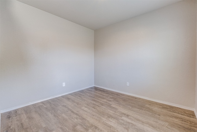 unfurnished room with wood-type flooring