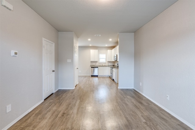 unfurnished living room with light hardwood / wood-style floors