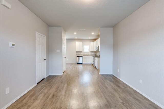 8236 Brucks Dr, San Antonio, TX 78244 - unfurnished living room with light wood-style flooring and recessed lighting