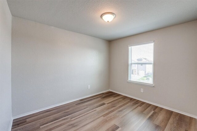 8236 Brucks Dr, San Antonio, TX 78244 - unfurnished room featuring wood finished floors and a textured ceiling
