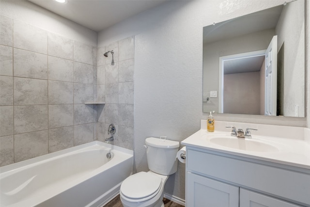 full bathroom with tiled shower / bath combo, toilet, and vanity