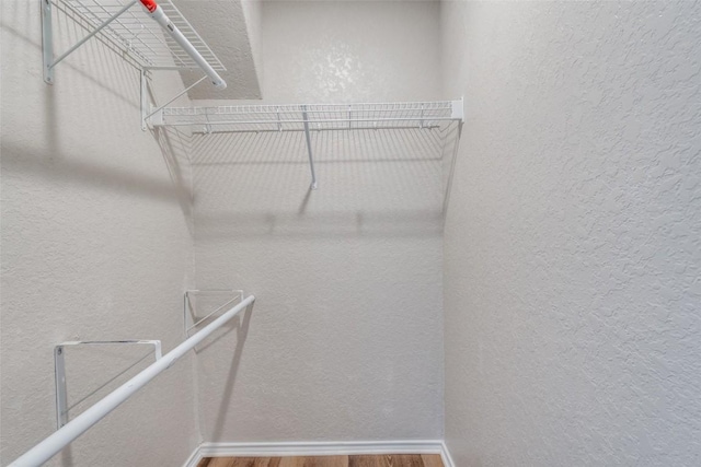 walk in closet featuring wood finished floors