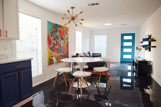 dining space featuring a notable chandelier and plenty of natural light