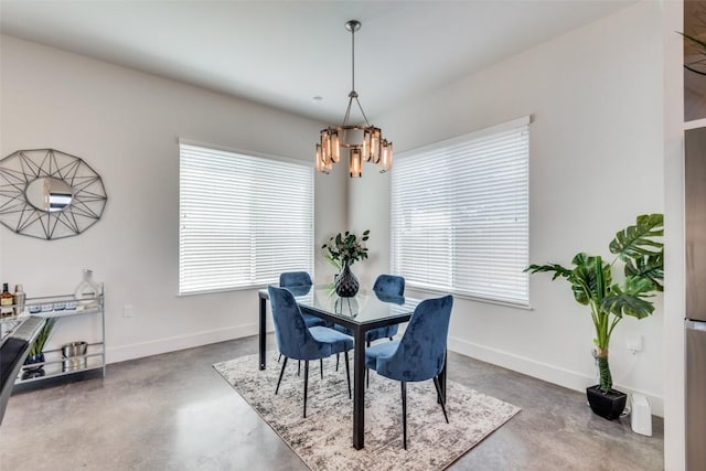 6217 Clovis St Unit A, Austin, TX 78741 - dining area featuring finished concrete floors, a chandelier, plenty of natural light, and baseboards