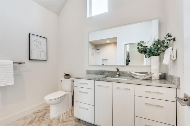 6217 Clovis St Unit A, Austin, TX 78741 - bathroom with toilet, vanity, baseboards, and vaulted ceiling