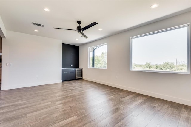 spare room featuring recessed lighting, visible vents, light wood-style flooring, ceiling fan, and baseboards