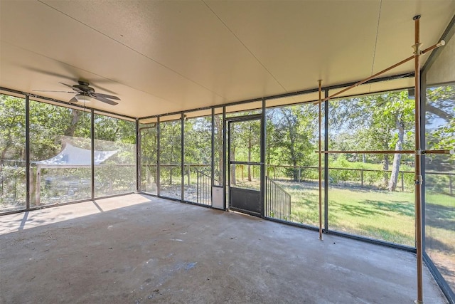 unfurnished sunroom featuring ceiling fan