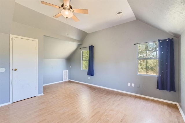 bonus room featuring vaulted ceiling, light hardwood / wood-style flooring, plenty of natural light, and ceiling fan