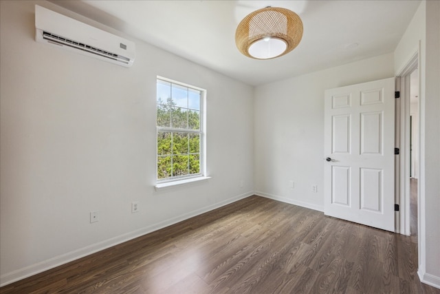 unfurnished room featuring a wall mounted AC and wood-type flooring