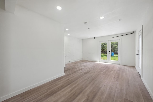 unfurnished room featuring french doors and wood-type flooring