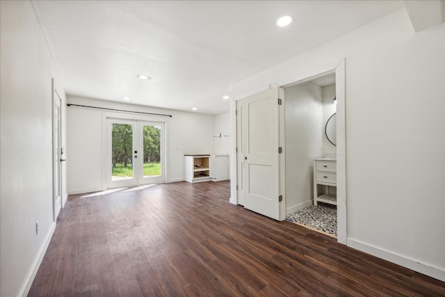 unfurnished living room with wood-type flooring and french doors