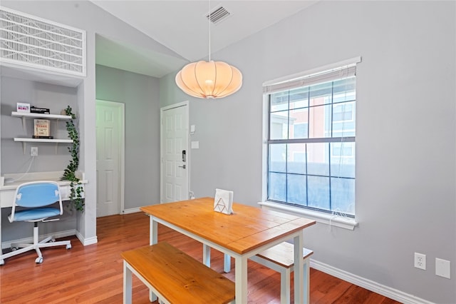 dining space featuring lofted ceiling and hardwood / wood-style floors