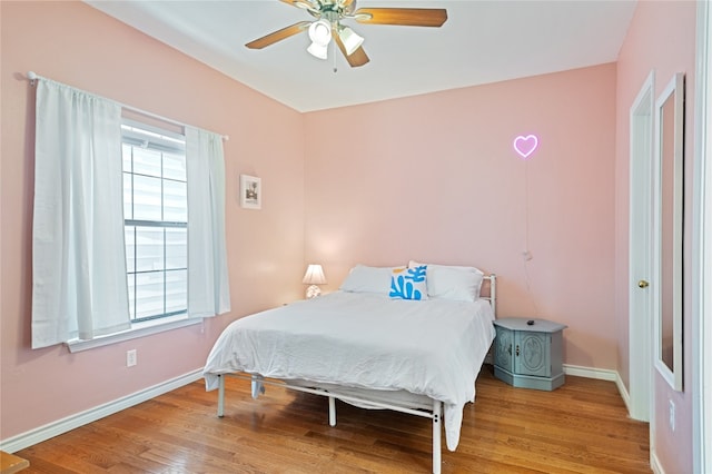 bedroom with ceiling fan and light hardwood / wood-style floors