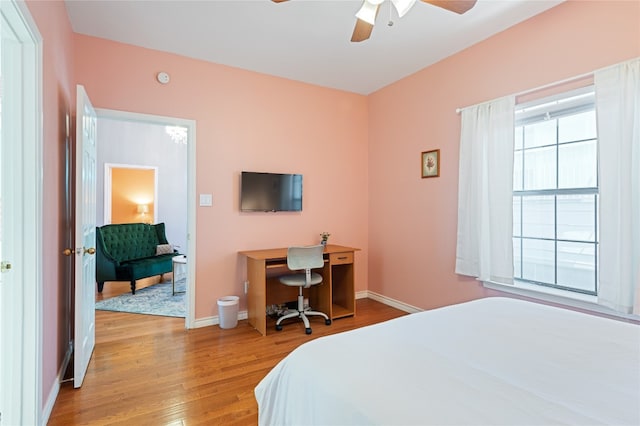 bedroom with ceiling fan and light hardwood / wood-style flooring