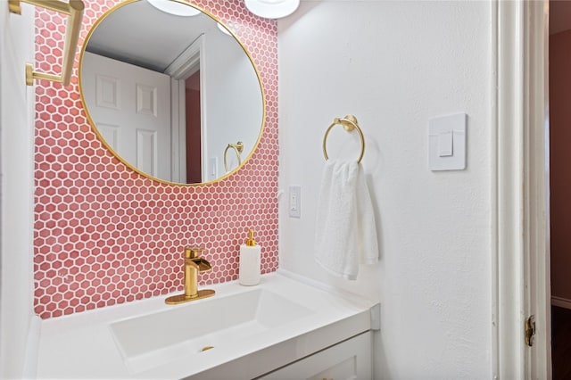 bathroom with vanity and tasteful backsplash