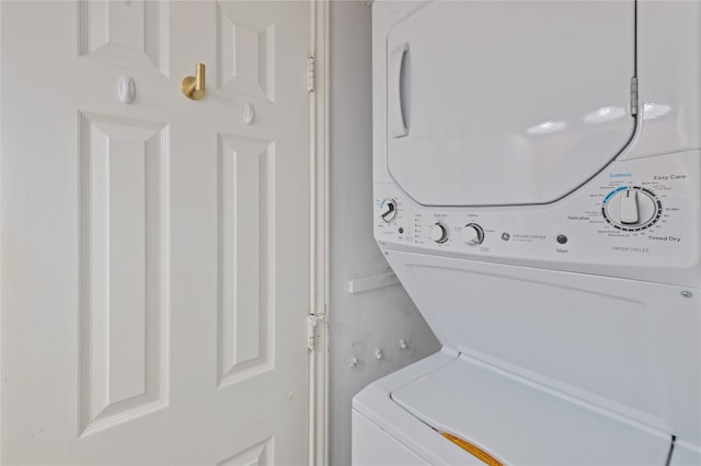 clothes washing area with stacked washer and clothes dryer