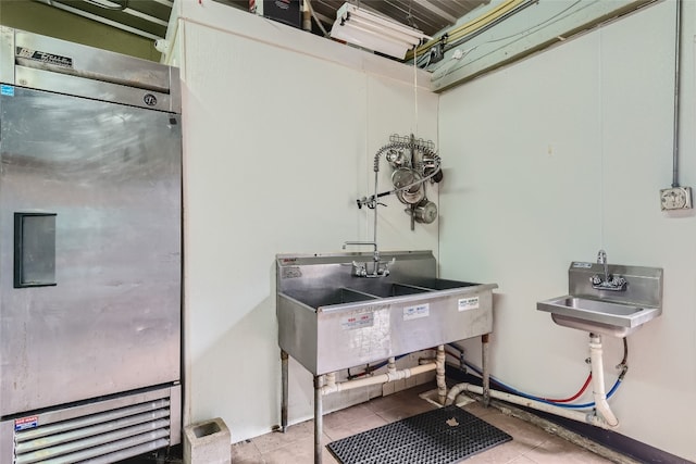 miscellaneous room with sink and light tile patterned flooring