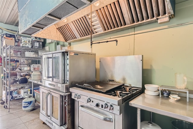 kitchen featuring range and light tile patterned floors