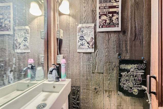 bathroom featuring wooden walls and vanity