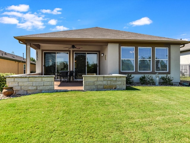 back of house with a patio area, a lawn, and ceiling fan