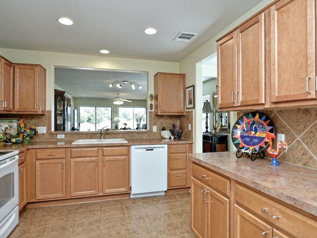 kitchen with white appliances, ceiling fan, tasteful backsplash, and sink