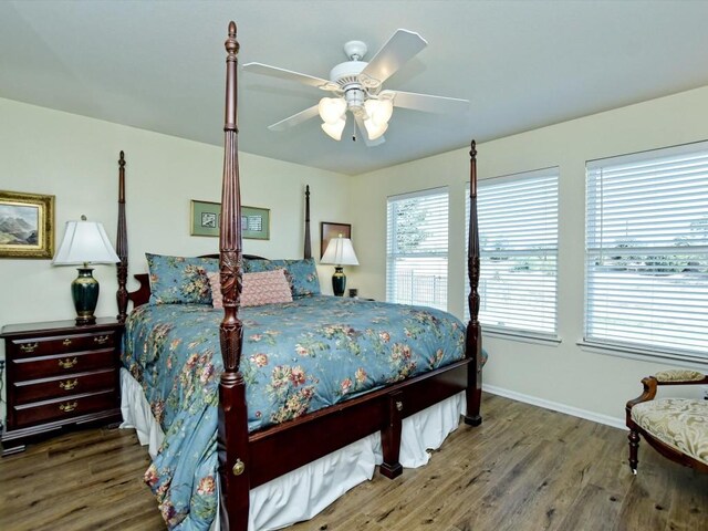 bedroom featuring ceiling fan and dark hardwood / wood-style floors